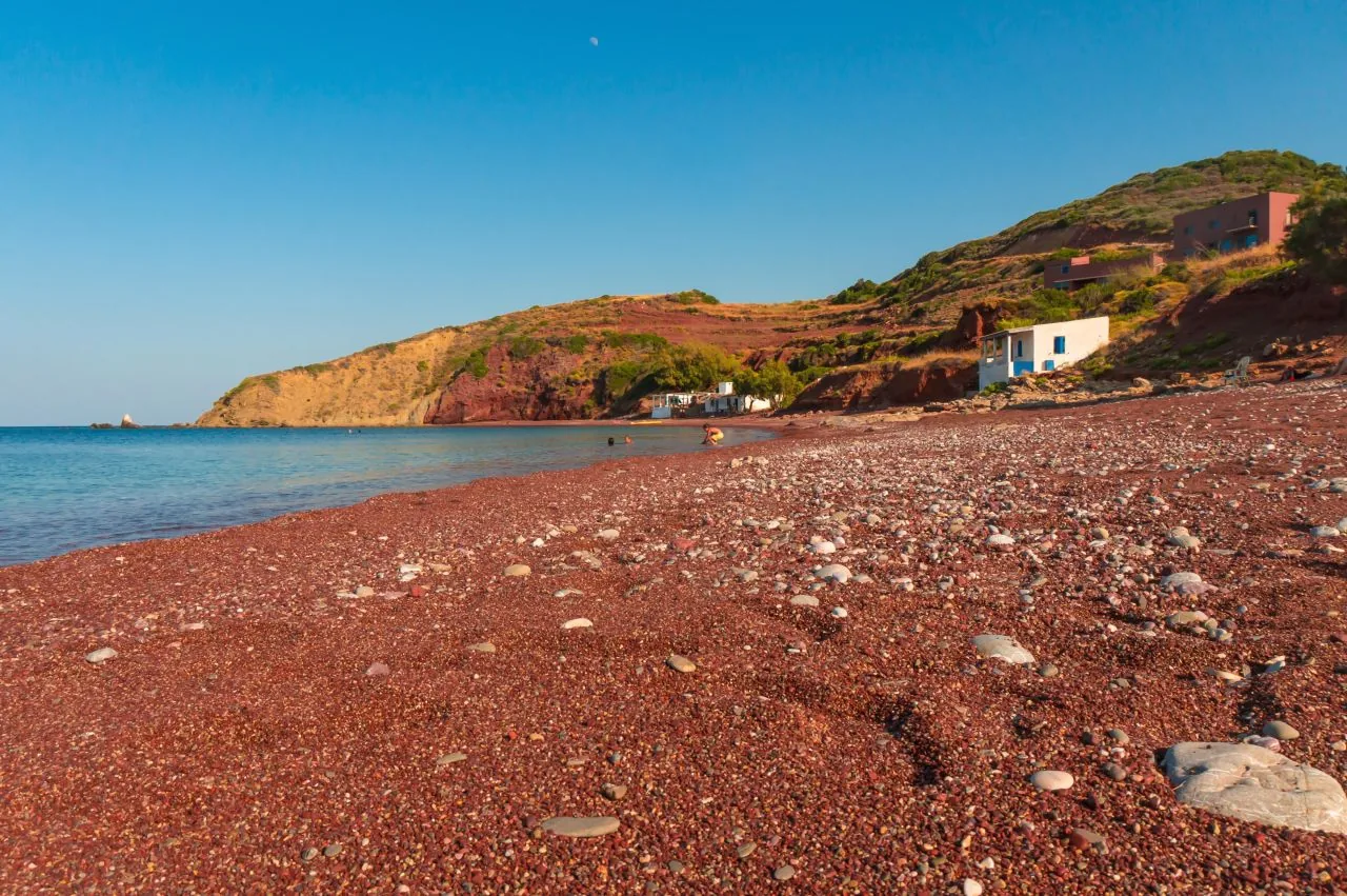 Reddish pebble beach and rocky shore on Kythira