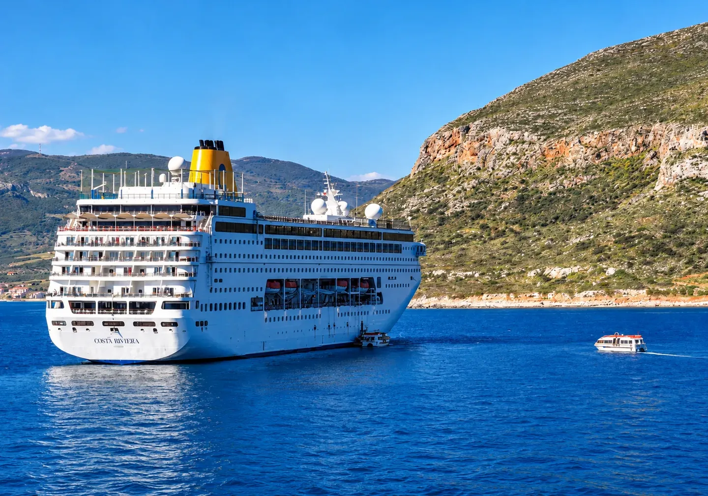Ferry crossing the sea towards Kythira, with rocky hills behind it